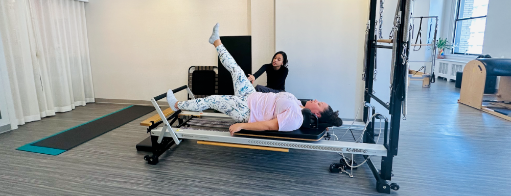 Jess works on Pilates equipment to improve mobility due to hip and SI joint pain.