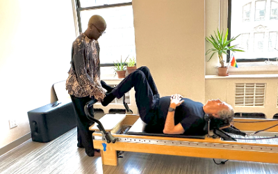 A DBP instructors guides Stew through exercises to relieve back pain with Pilates